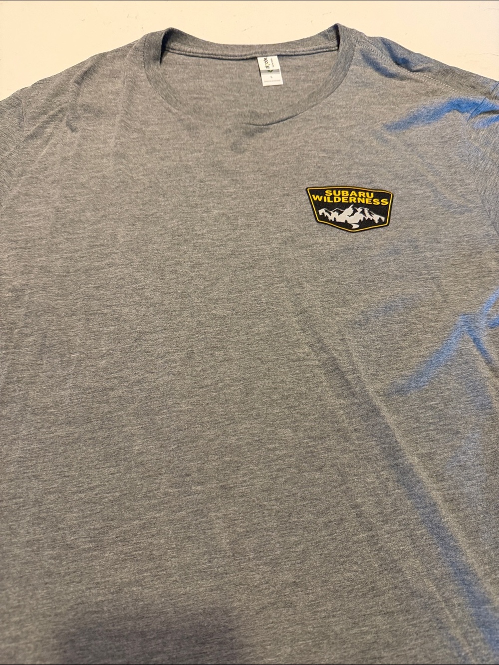 Subaru Gray Short Sleeve Tee with Yellow & Black Subaru Wilderness Patch